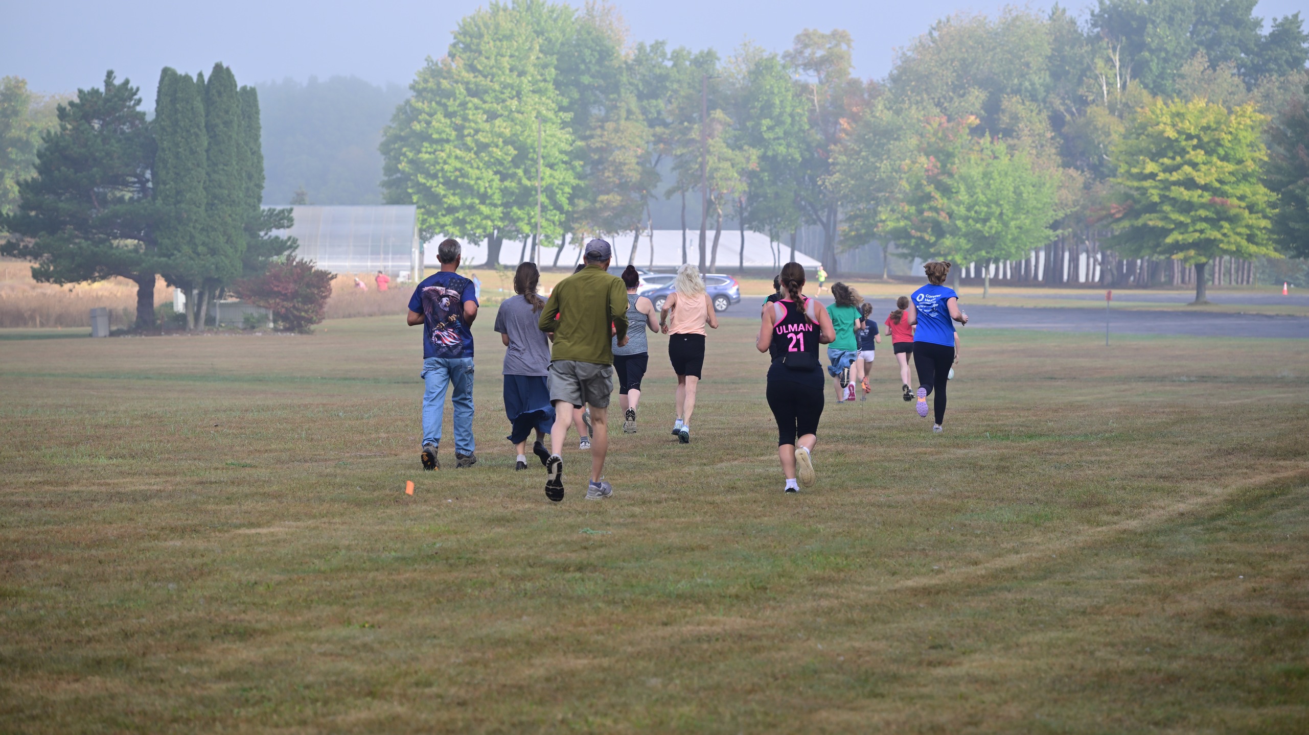 Group of people running outside on MCC's Sidney campus.