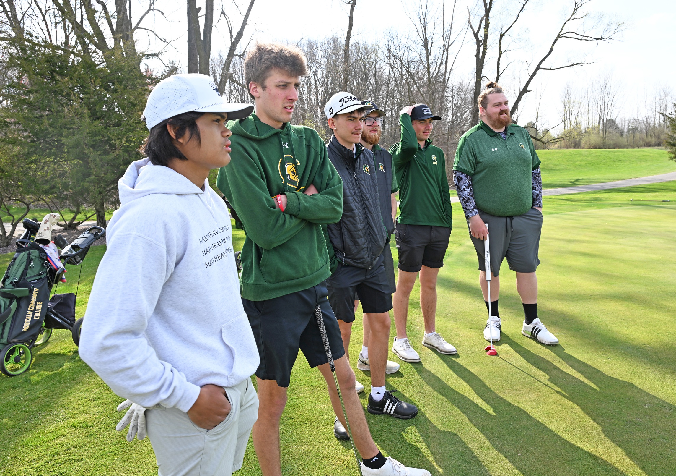 MCC Men's Golf Team standing on the green.