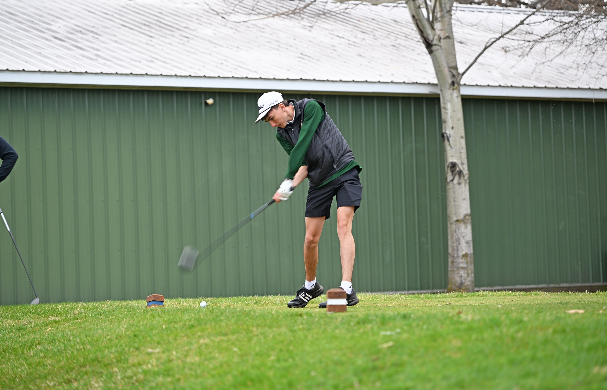 MCC golfer driving ball.