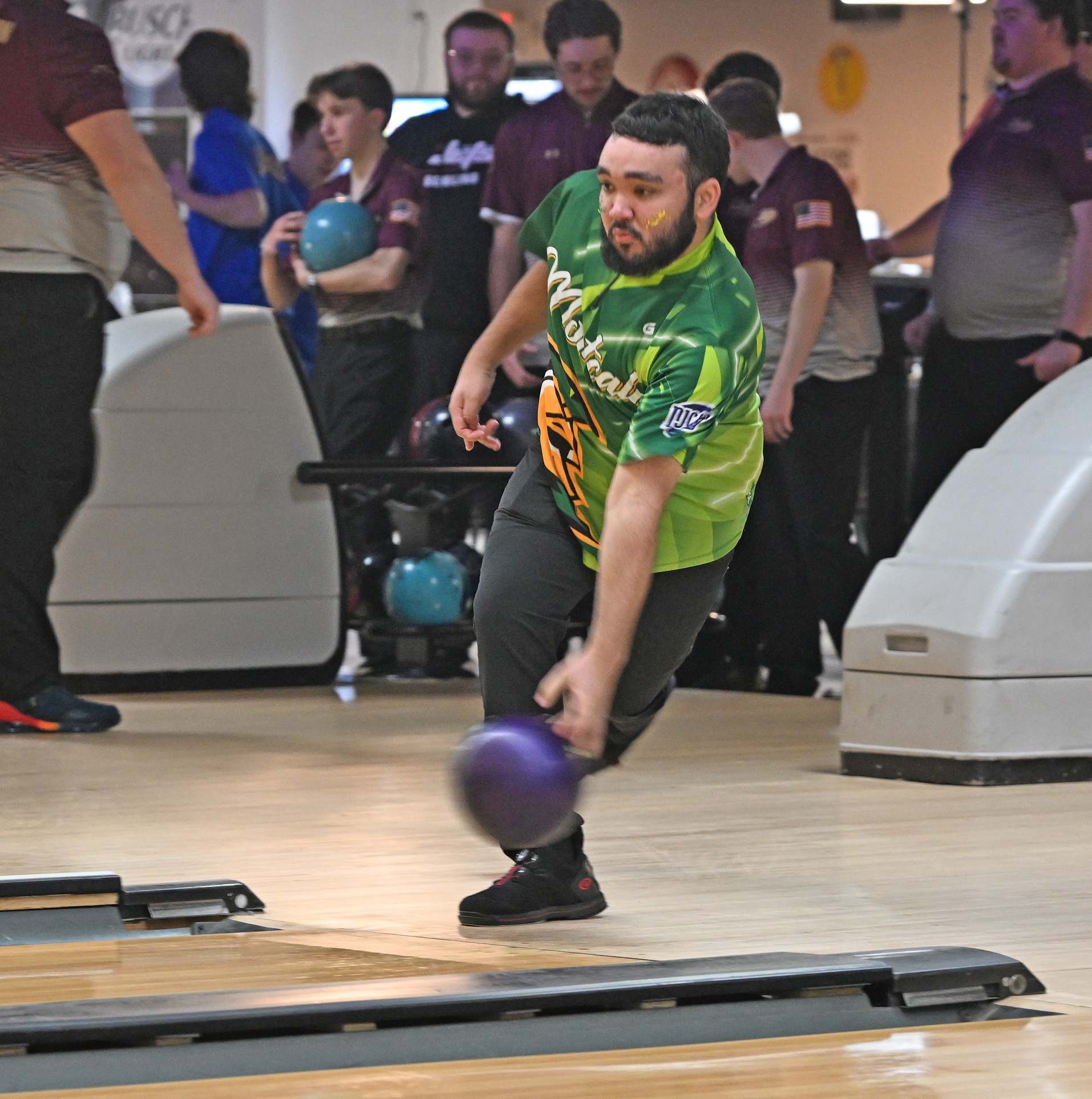 MCC men's bolwer throwing a purple ball down the lane during the MCC home invite at the Greenville Hot Spot.